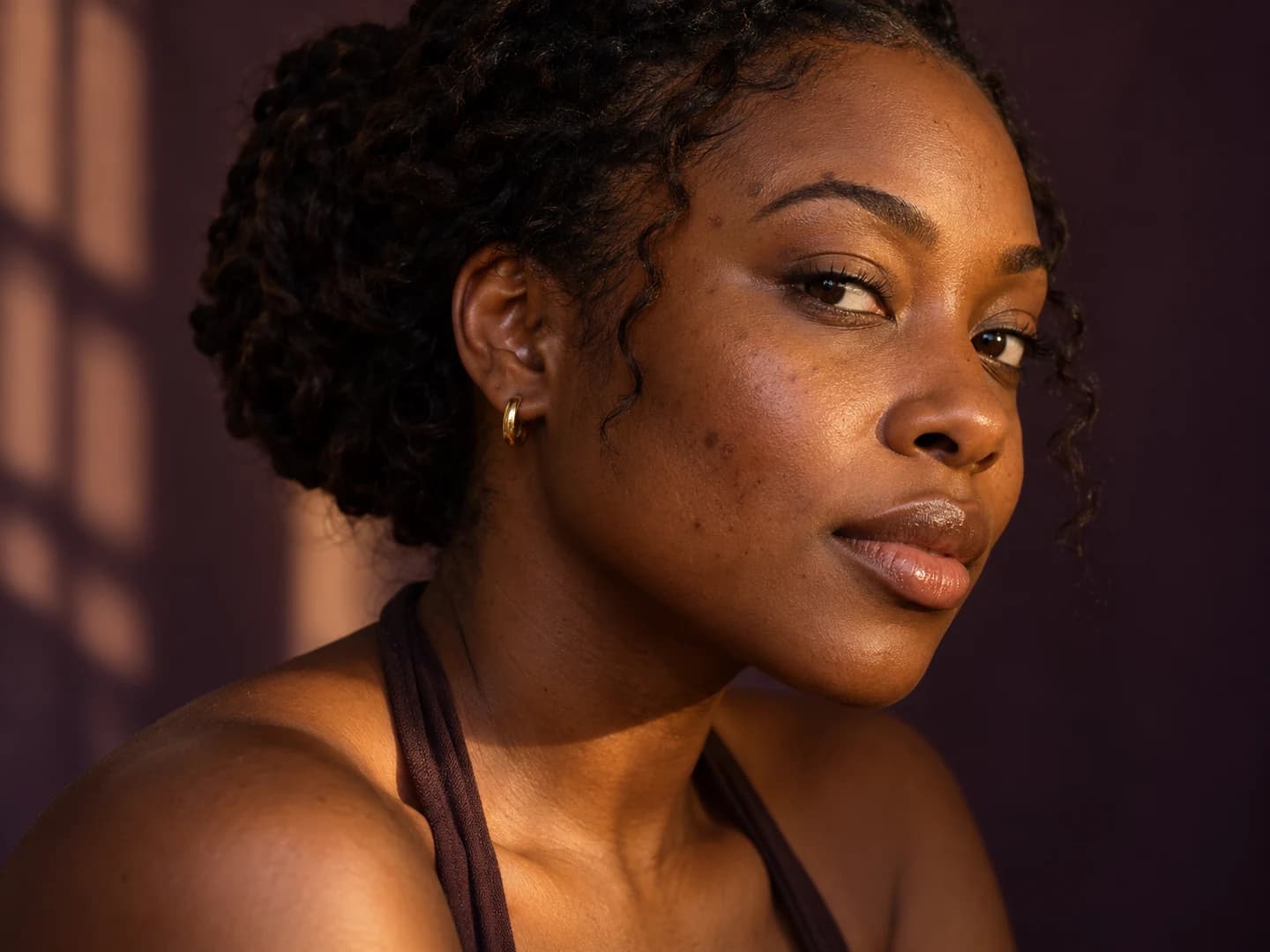 Warm side-lit portrait showing a subtle reduction in visible post-acne marks original